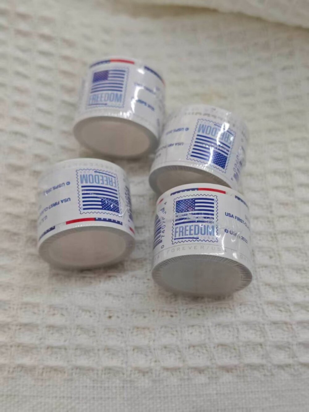 10 rolls of U.S. Postal Service stamps, totaling 1,000 brand new stamps.